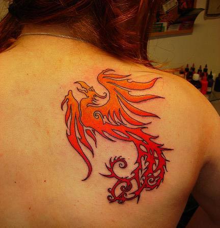 The smooth fade from orange to red in this phoenix tattoo looks great